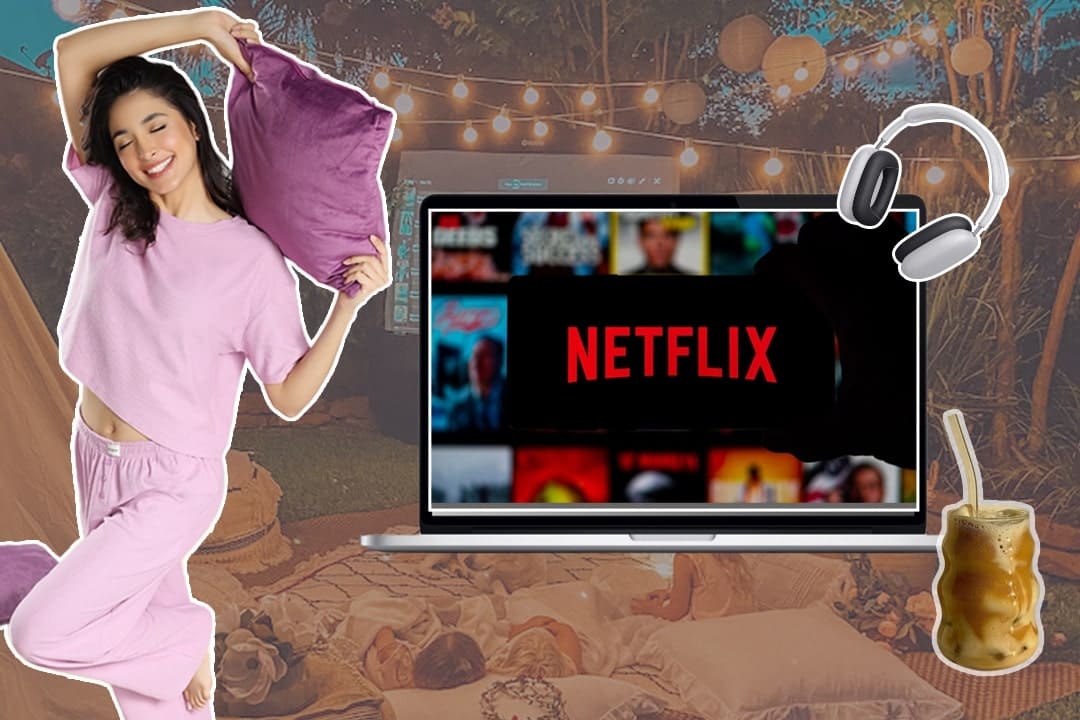 a woman lounging indoors in soft loungewear, surrounded by books, a laptop playing a show, and a warm drink